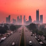 a photo of the delhi skyline with a red sky due to delhi bans bs3 and bs4 vehicles as aqi hits
